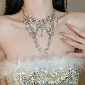 Close-up of luxury silver layered tassel necklace with rhinestones on a model