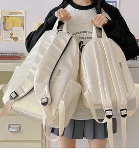 Size comparison of white waterproof minimalist backpacks in large and small versions