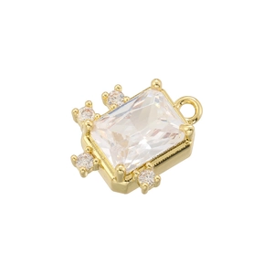 Macro shot of gold-plated square pendant with sparkling clear crystals on white background