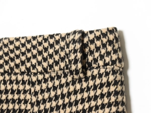 Detail of classic houndstooth trousers with high-density jacquard waist and buckle