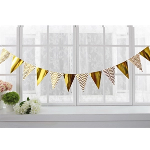 Detail of gold triangle pennant banner hanging by a window for birthday party decoration
