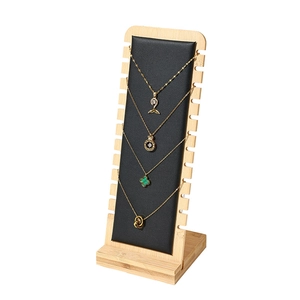 Bamboo and wood necklace display stand with black leather padding for jewelry photography