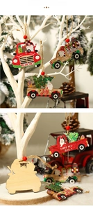 Close-up of festive wooden truck ornaments hanging with jute rope and red beads