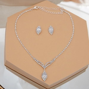 Close-up of silver bridal jewelry set with marquise cut zircon and tassel detailing