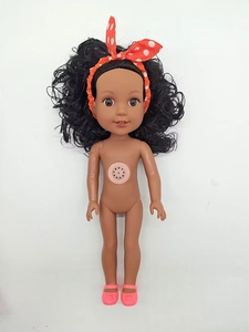 Detail of a black vinyl doll with curly hair, red headband, and chest music speaker