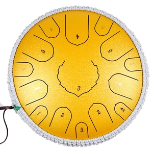 Yellow steel tongue drum with braided white rope border and numbered scale markings
