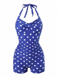Detail of royal blue polka dot halter swimsuit with slimming ruched front and vintage cut