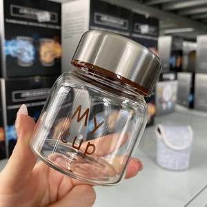 Detail of a mini 150ml borosilicate glass jar with My cup text and silver screw lid