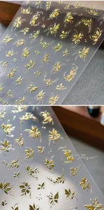 Detail of luxury gold 3D embossed nail art stickers with butterfly and flower patterns