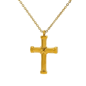 Close-up of golden cross pendant necklace with sparkling diamonds on a white background