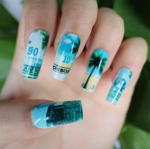 Long press-on nails with tropical palm trees and abstract currency pattern beach design