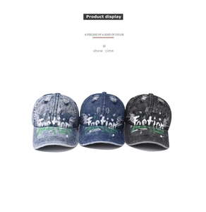 Detailed view of washed denim baseball caps with vintage graffiti in various colors