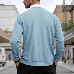 Men's light blue waffle knit long sleeve polo shirt with textured fabric and white collar