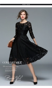 Detail of elegant black lace dress with intricate hollow pattern and A-line silhouette