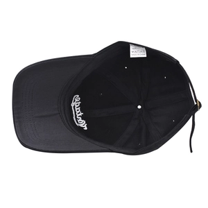Detailed interior view of vintage black cotton baseball cap showing care label