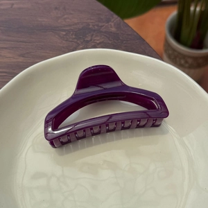 Detail of 10cm dark purple butterfly perfume bottle hair claw clip on ceramic plate