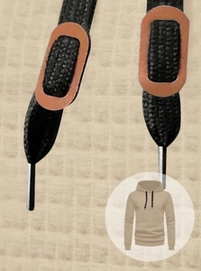 Close-up of khaki waffle knit fabric and black drawstring with leather trim and metal tips