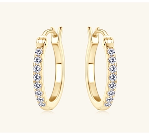 Close-up of golden hoop earrings featuring micro-paved sparkling moissanite stones