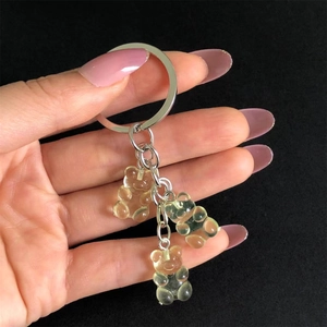 Macro shot of three light yellow jelly resin bears on a silver metal keychain