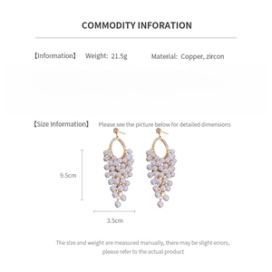 Detail view of pearl tassel earrings showing copper zircon specs and 9.5cm length