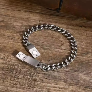 Close-up of silver Cuban chain bracelet featuring a functional magnetic clasp detail