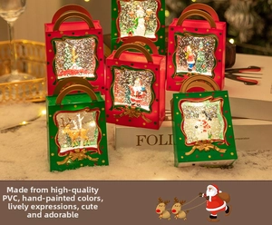 Detail of Christmas lantern gift boxes with warm LED lights and holiday scene figurines