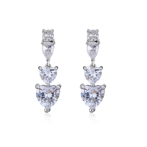 Detail of silver drop earrings featuring tiered heart and pear-shaped cubic zirconia crystals