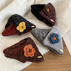Winter plush triangle hair claws with knitted flowers and polka dots on soft background