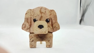 Macro detail of wooden teddy dog eyeglass stand with realistic brown wood grain textures