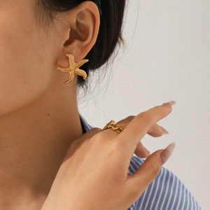 18k gold plated stainless steel starfish earring and ring set shown on model