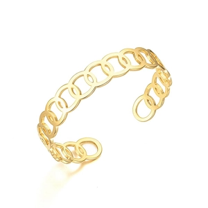 Detail of a gold-plated titanium steel open cuff bracelet with interlocking circle design.