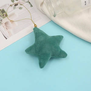 Detailed view of a plush dark green star pendant with a gold cord and bead accessory