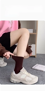 Detail of dark brown ribbed cotton socks showing the high elasticity Lycra fabric stretch