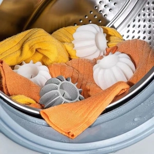 Anti-winding laundry ball for washing machines shown with fabrics inside a drum