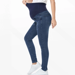 Detail view of high-waisted maternity skinny jeans featuring elastic belly support band