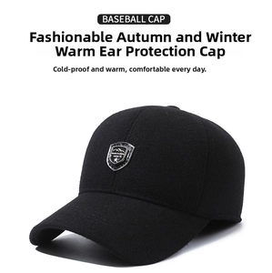 Detail of winter baseball cap with ear flaps and metal sport emblem on thick wool fabric