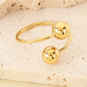 Macro shot of 18k gold plated stainless steel open ring with dual geometric spheres