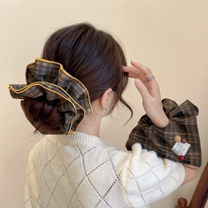 Large yellow checkered hair scrunchie with button accents for elegant low ponytail styles