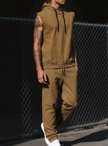 Detail of mustard yellow sleeveless hoodie set with premium cotton texture in urban setting