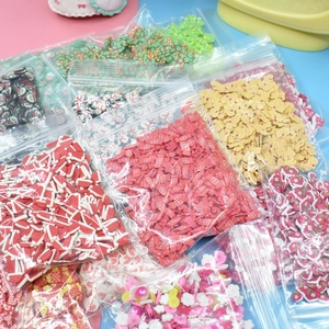 Mix of colorful Christmas polymer clay slices for DIY crafts in clear poly bags