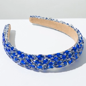 Macro detail of deep blue marquise-cut crystals on luxury padded velvet headband