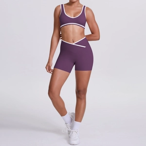 Two-piece dark purple yoga set with contrast white piping and crossover high waist shorts