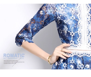 Detail of floral hollow lace dress featuring blue and white embroidery and stylish 3/4 sleeves