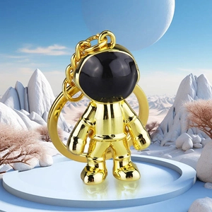 Golden astronaut keychain on moon base platform with glowing cosmic space background