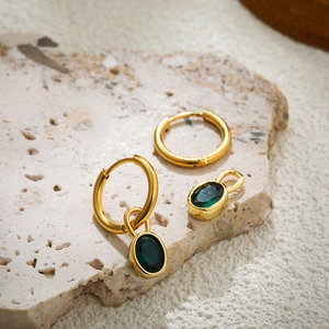 Macro shot of 18K gold plated hoop earrings with detachable oval green agate pendants