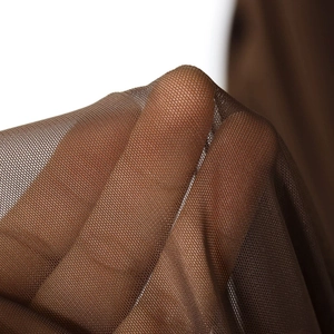 Close-up of brown mesh fabric showing breathable texture and elastic mesh material