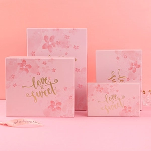 Set of four pink square gift boxes with floral patterns and Love is Sweet gold foil print