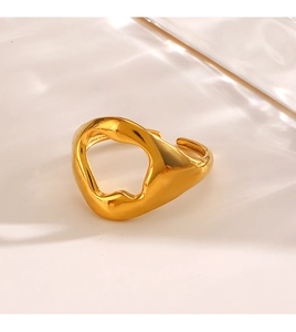 Detailed view of an irregular hollow gold ring with high-polish metallic finish