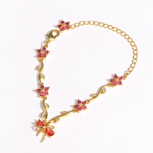 Detail of gold bow bracelet with pink zircon flowers and adjustable lobster clasp
