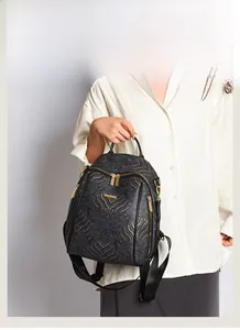 Close-up of black and gold Chinoiserie backpack featuring traditional cloud patterns